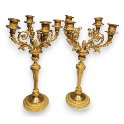 A pair of Louis XVI candlesticks in gilded bronze
