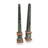 A pair of obelisks in green and pink marble
