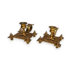 Pair of square-based candlesticks in gilded bronze