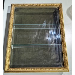 Small hanging display case with a gilded stucco frame