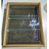 Small hanging display case with a gilded stucco frame